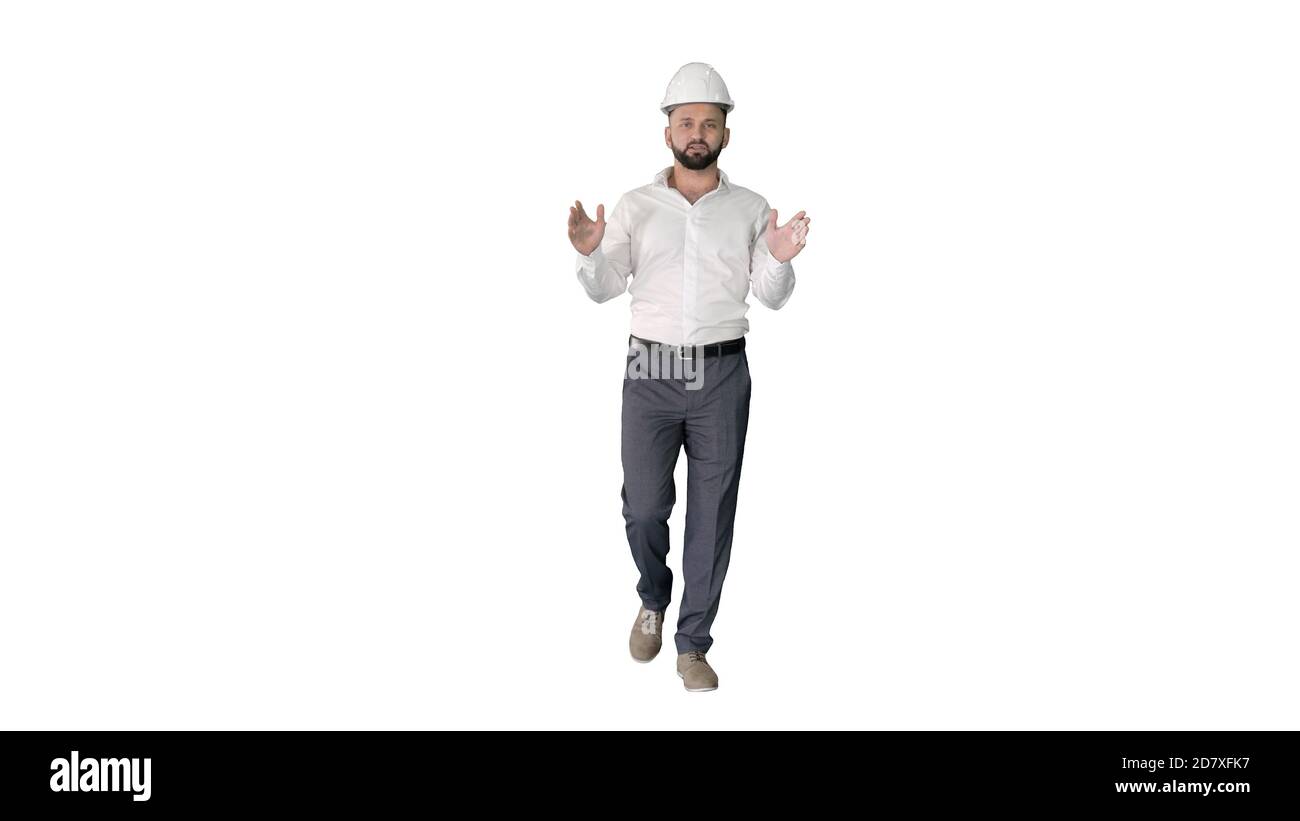 Engineer in hardhat walking and explaining something on white ba Stock Photo