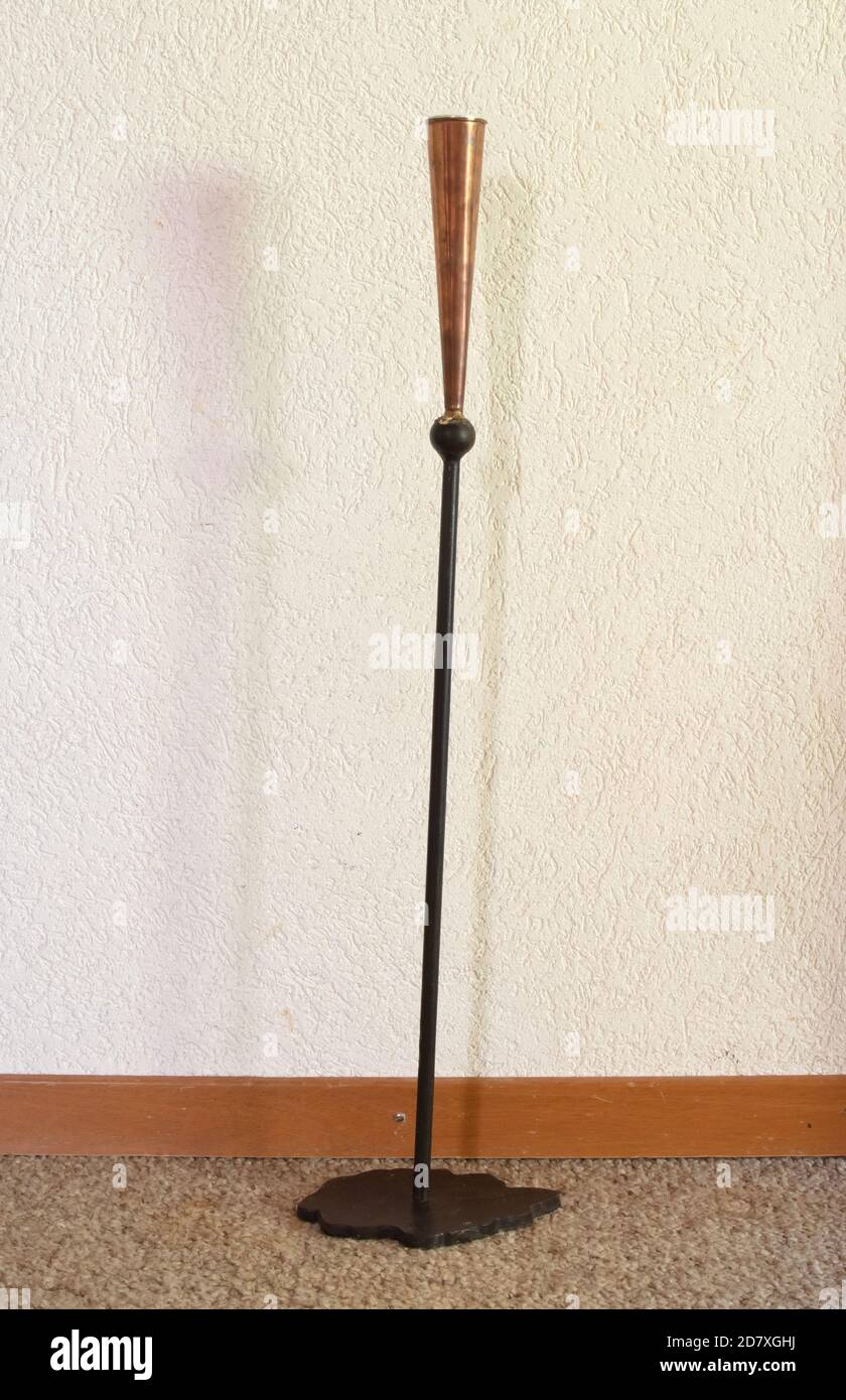 Old metal candle stand, white wall background Stock Photo Alamy