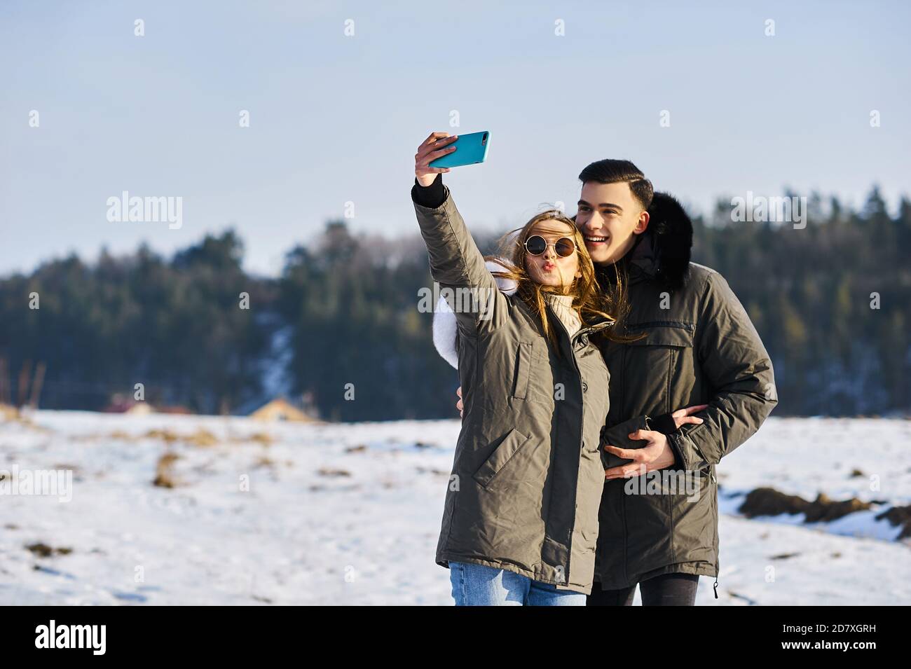 happy couple hugging and laughing outdoors in winter Stock Photo - Alamy