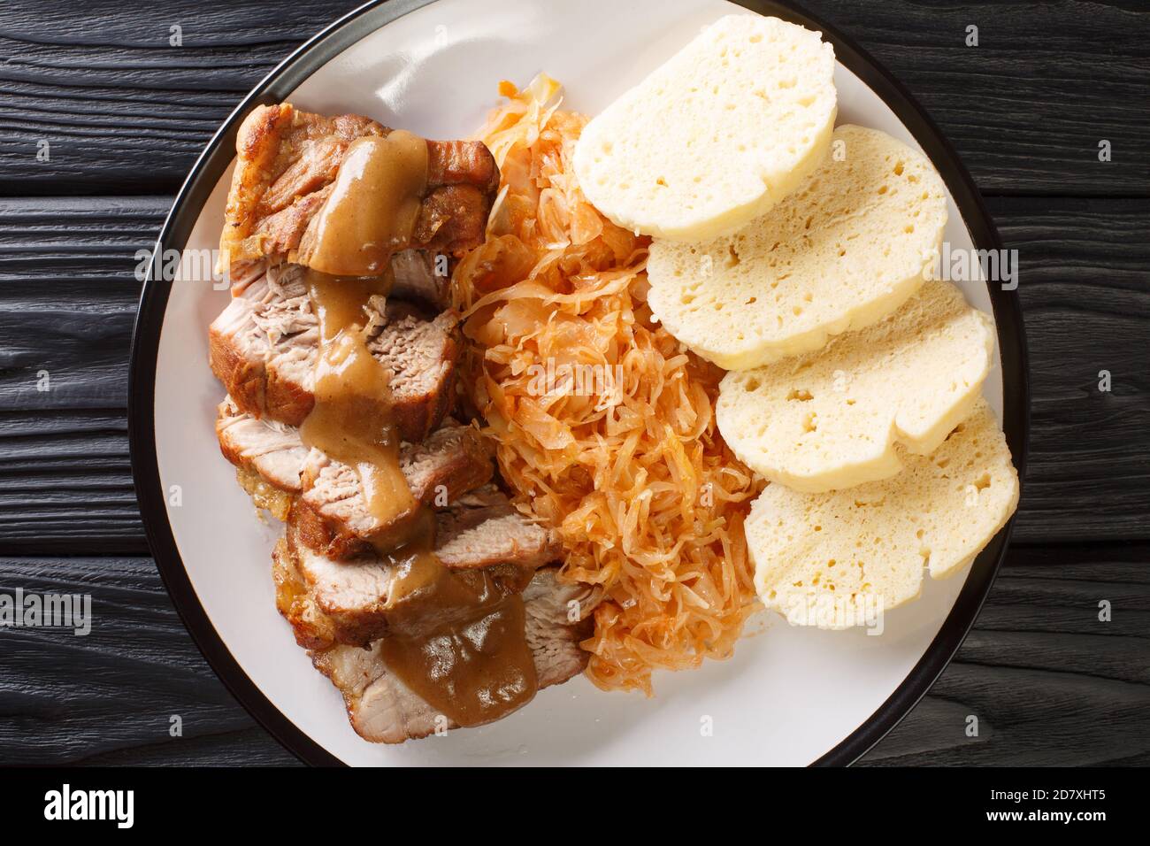 National Dish of Czech Republic Vepro Knedlo Zelo close-up in a plate on the table. Horizontal top view from above Stock Photo