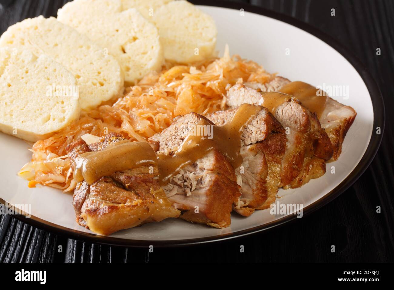 National Dish of Czech Republic Vepro Knedlo Zelo close-up in a plate on the table. Horizontal Stock Photo