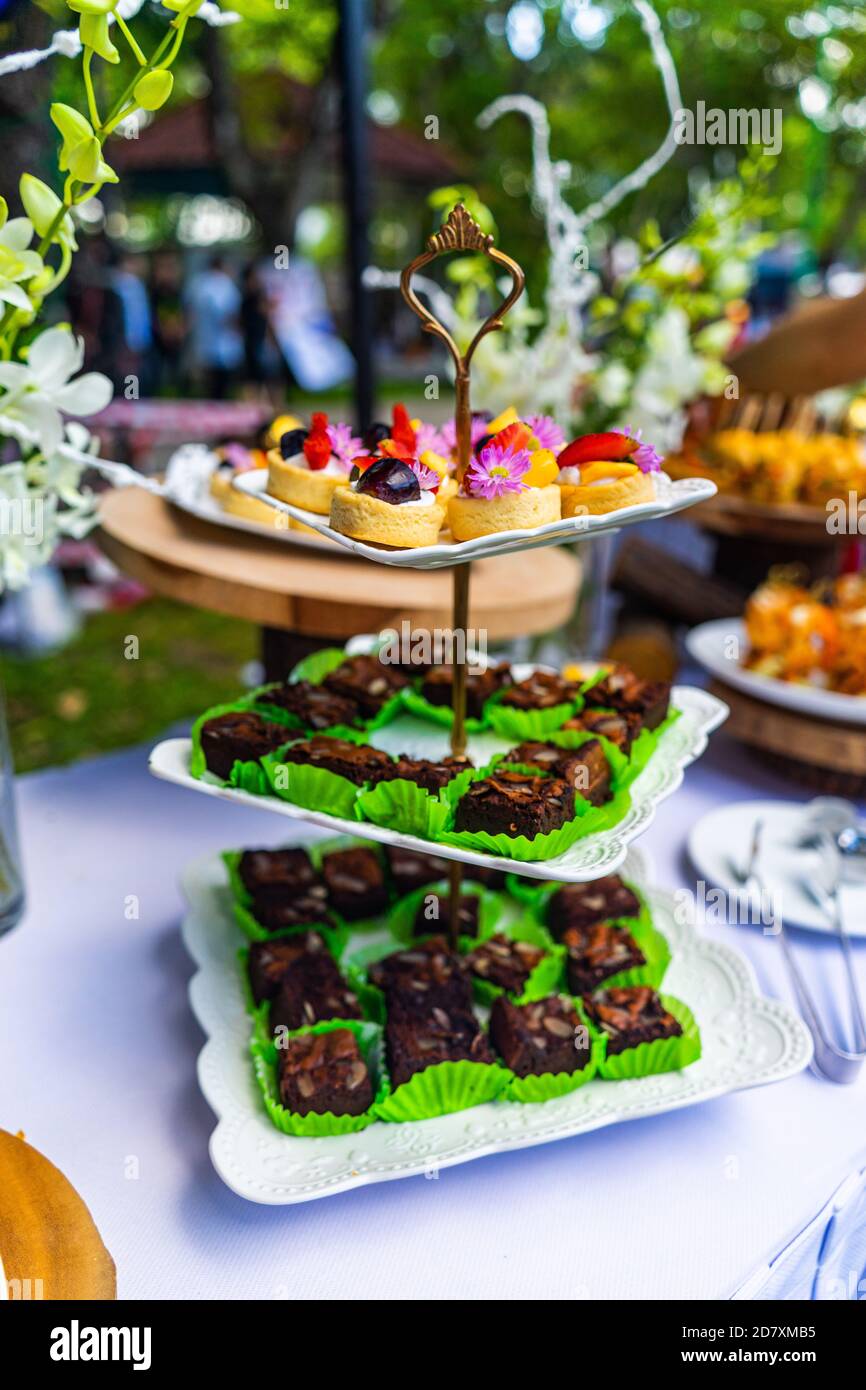 small cakes with different stuffing on party or wedding table. Selective focus. Stock Photo