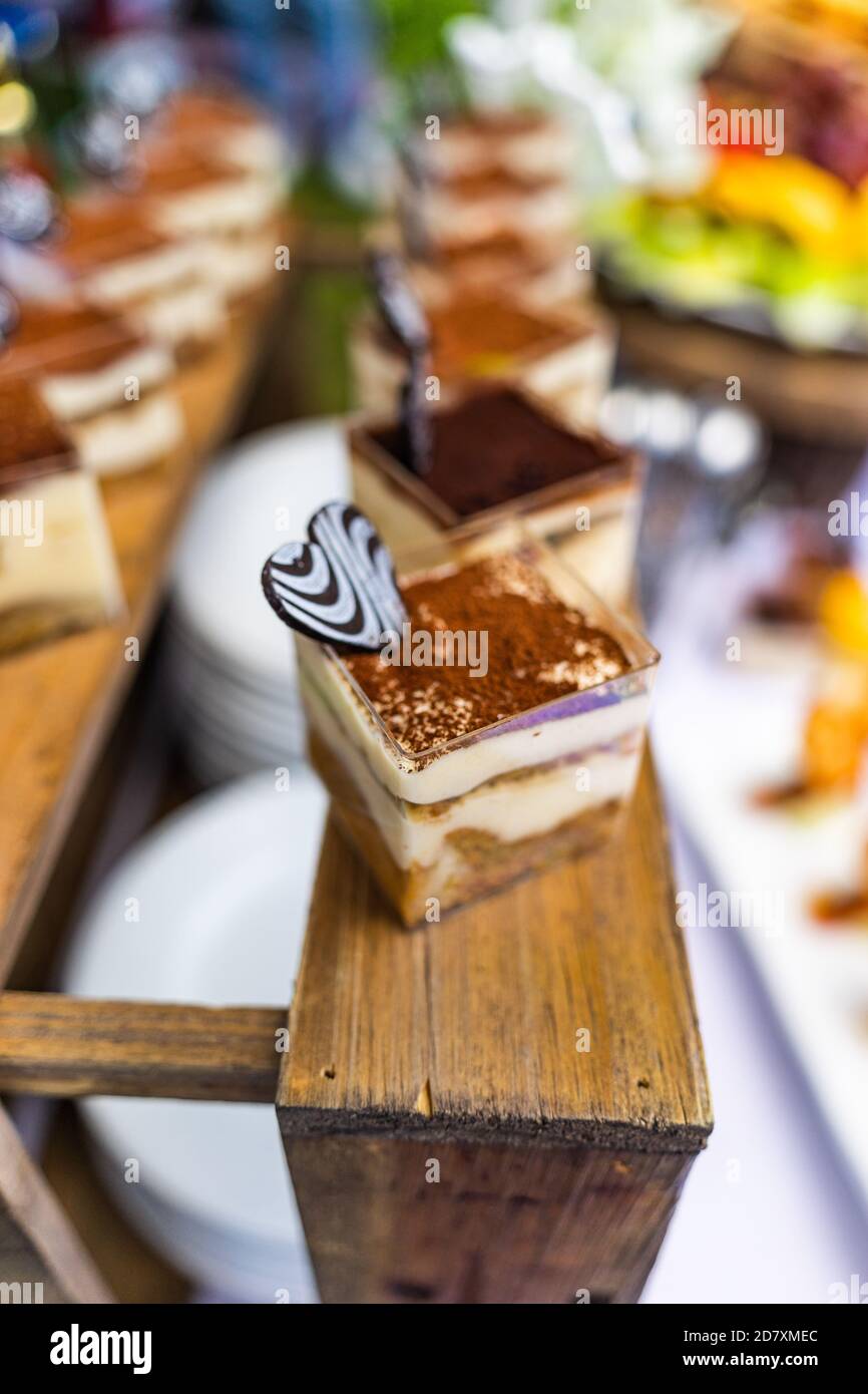 small cakes with different stuffing on party or wedding table. Selective focus. Stock Photo