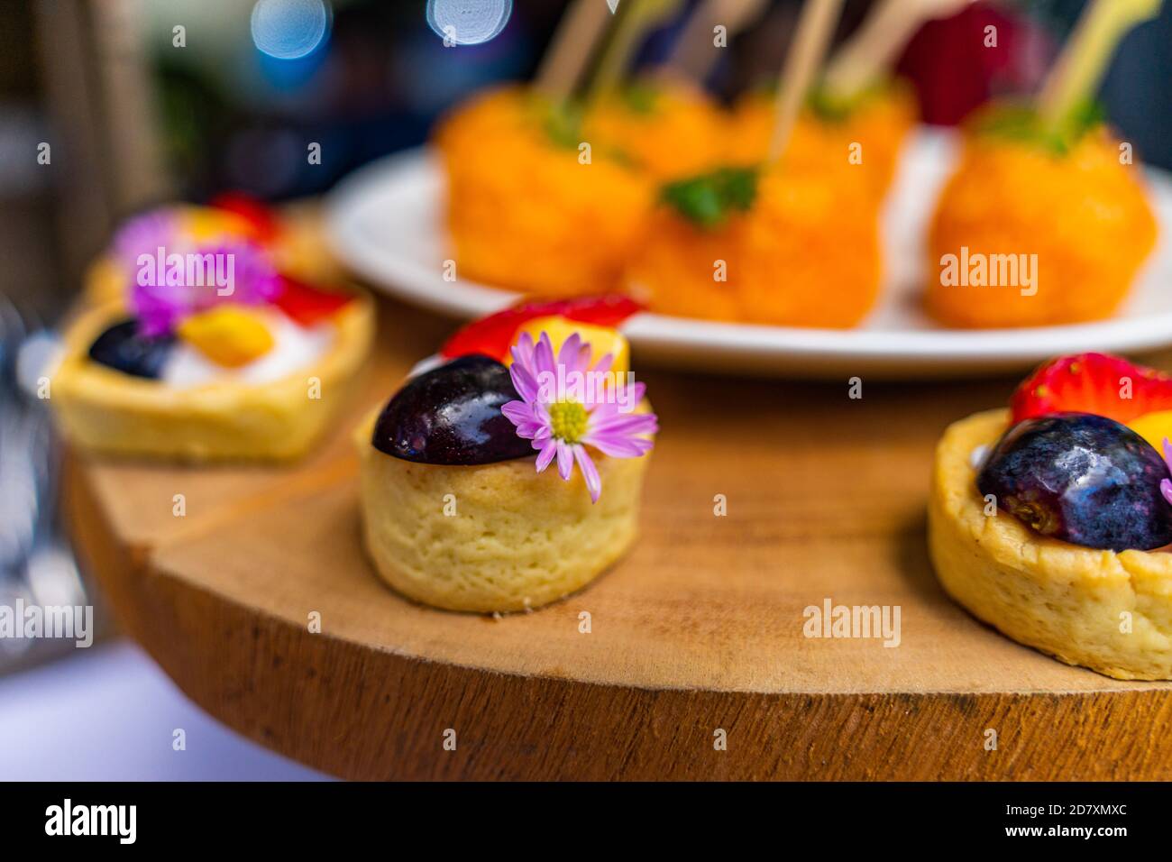 small cakes with different stuffing on party or wedding table. Selective focus. Stock Photo