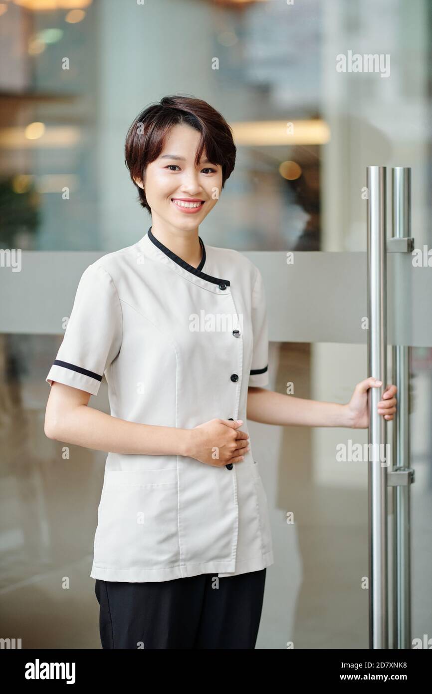 Cheerful Asian hotel manager Stock Photo - Alamy