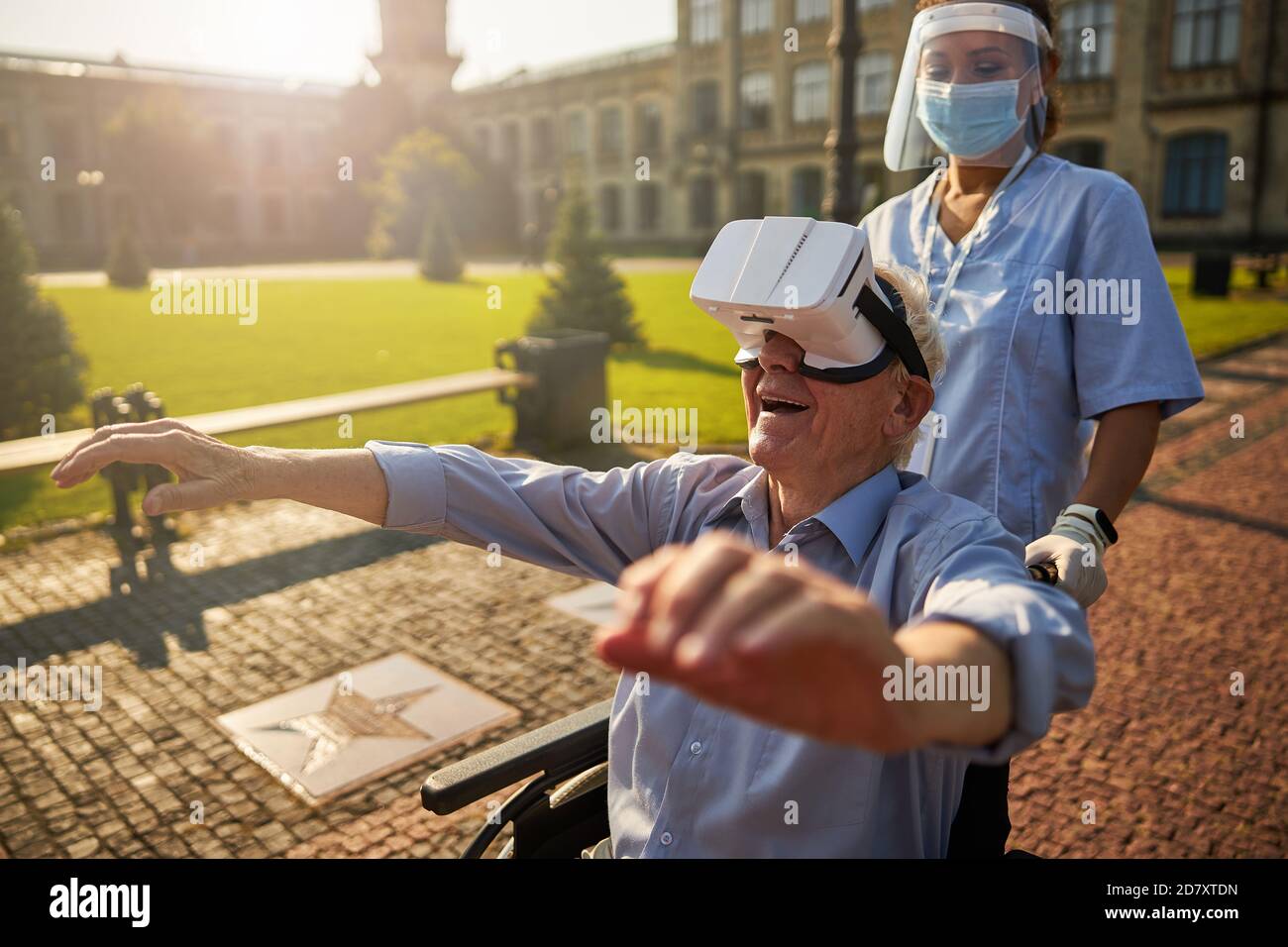 Smiling senior man using virtual reality device outdoors Stock Photo