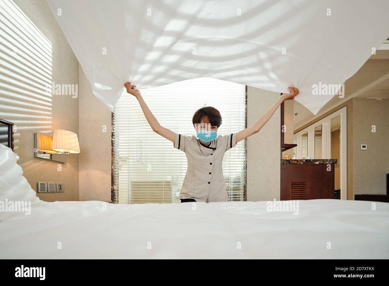 Hotel maid changing sheets Stock Photo Alamy