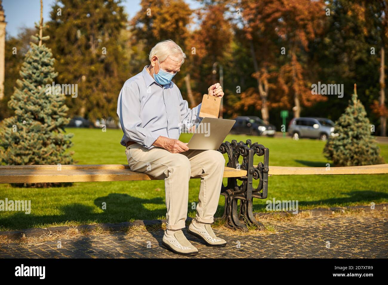 Senior man using laptop while looking at screen Stock Photo