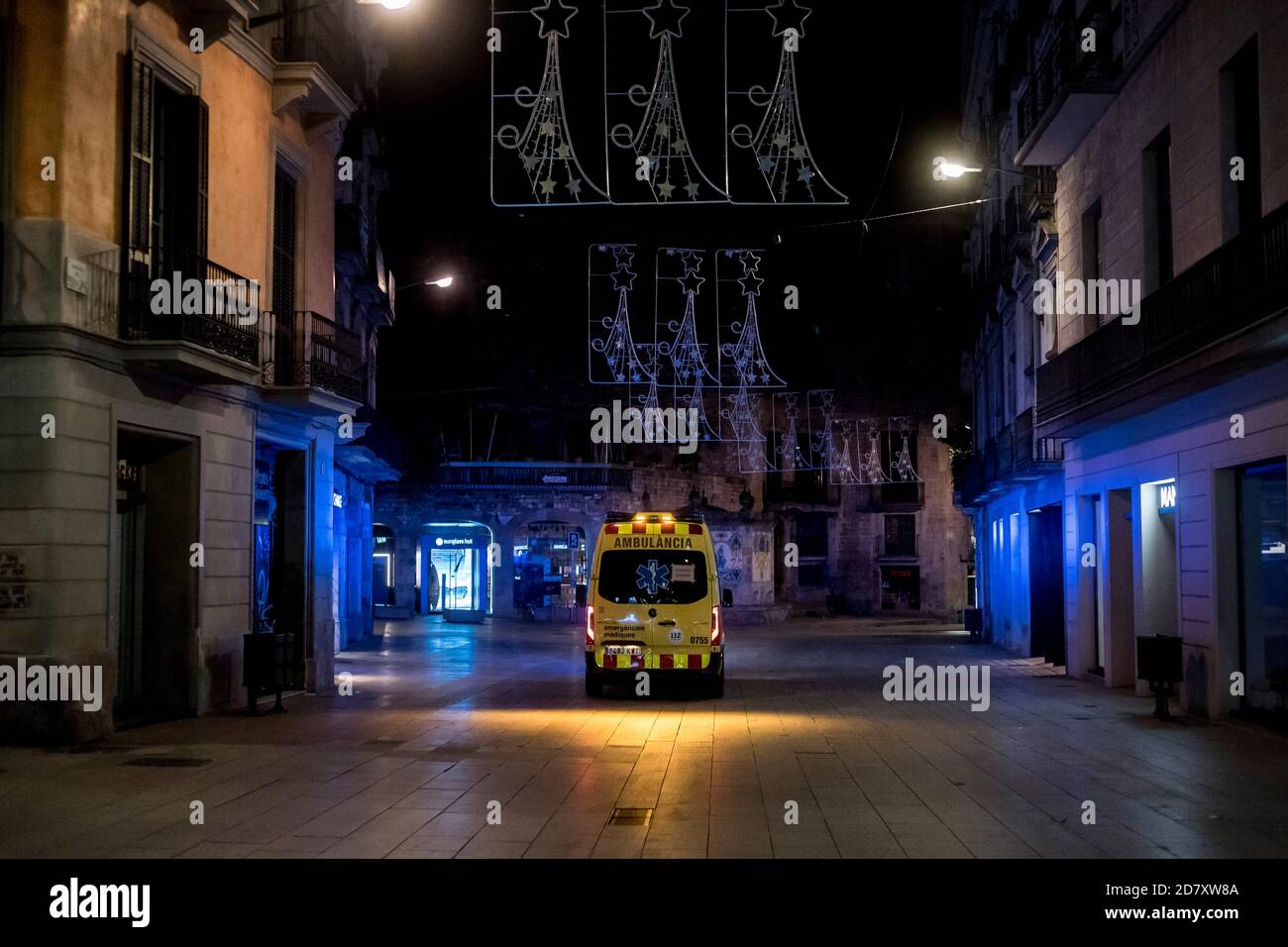 Barcelona, Spain. 25th Oct, 2020. October 25, 2020, Barcelona, Catalonia, Spain: An ambulance circulates through the lonely streets of the center of Barcelona. Spanish prime minister approved today a new state of emergency with plans to keep it in place until May and Catalan government imposes an obligatory curfew between 10pm and 6am. Credit: Jordi Boixareu/Alamy Live News Stock Photo