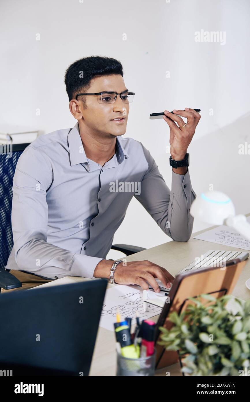 Programmer recording voice message Stock Photo