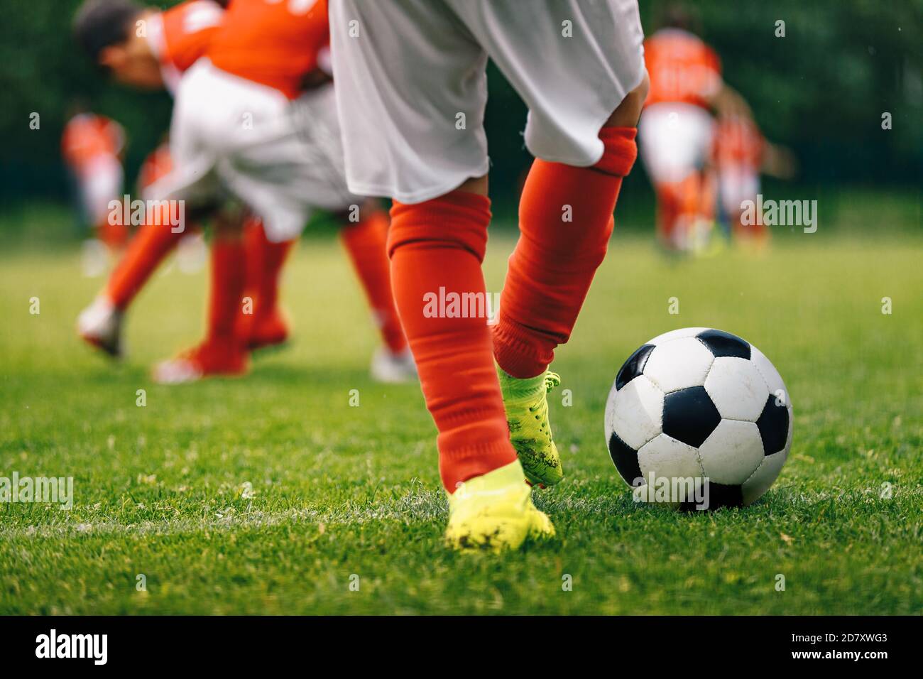 Child kicking a soccer ball hires stock photography and images Alamy