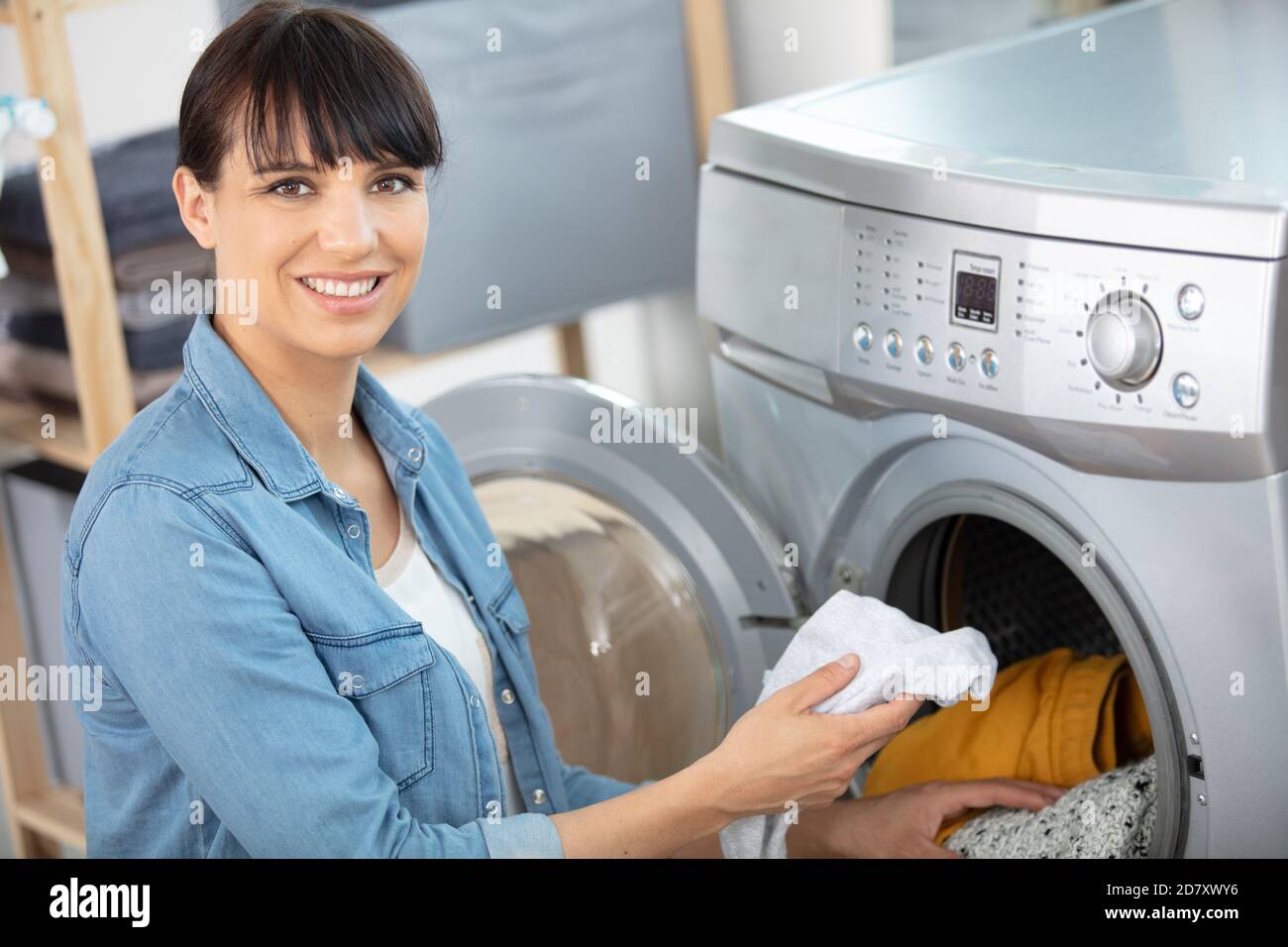 woman emptying a washing machine Stock Photo Alamy