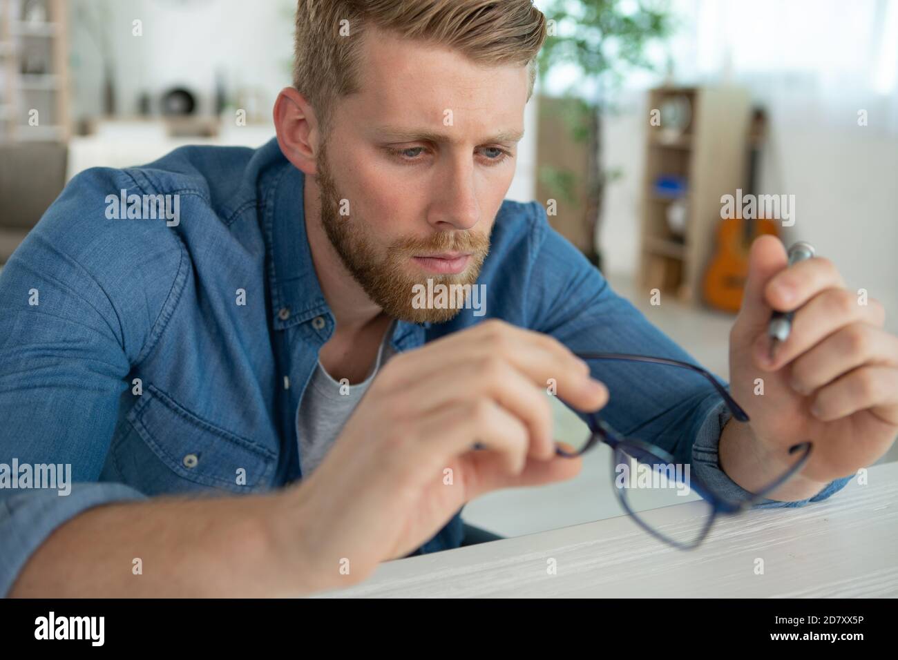 an optician repairing and fixing eye glasses Stock Photo Alamy