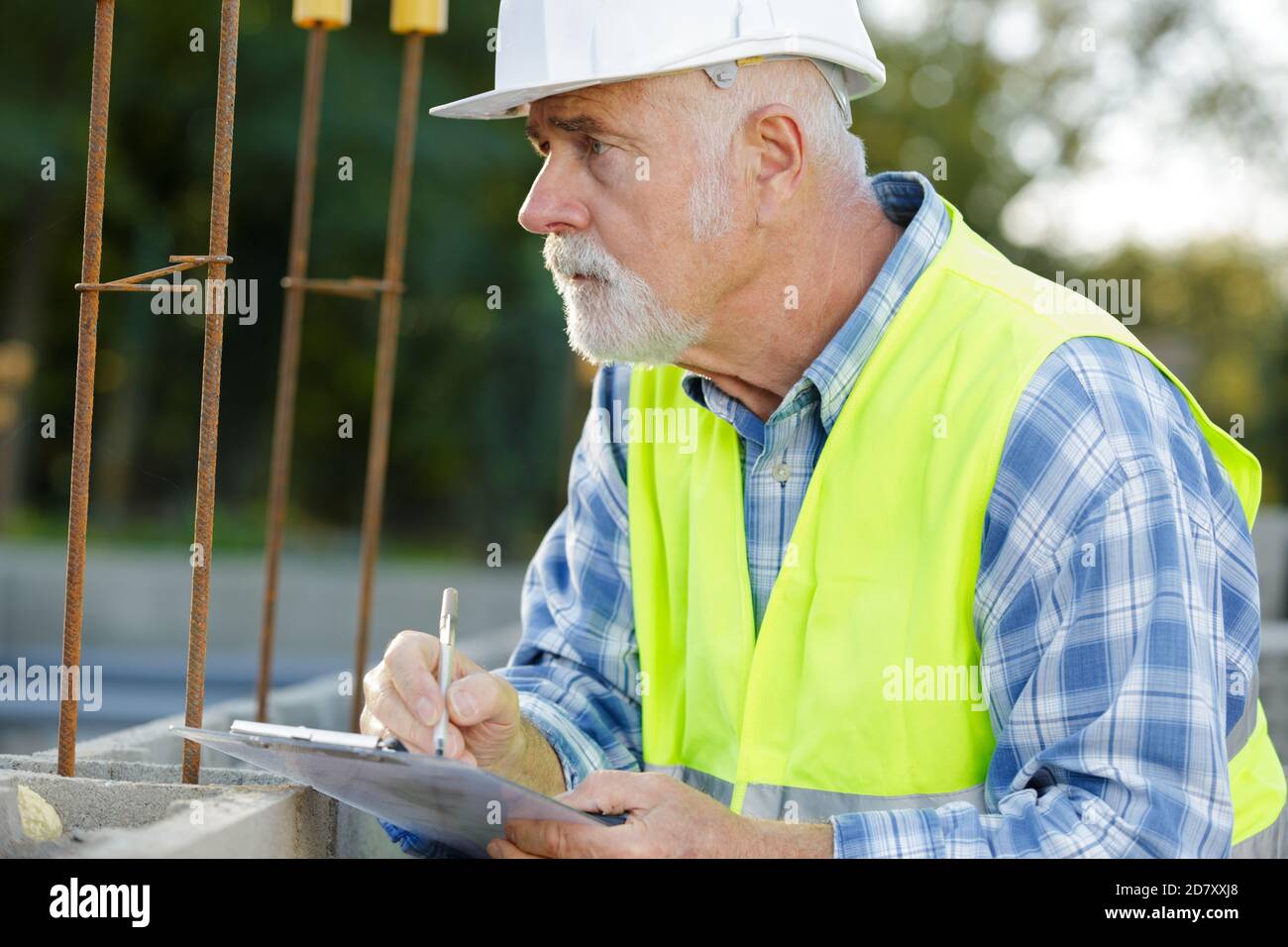 senior man working on metal structure outdoors Stock Photo