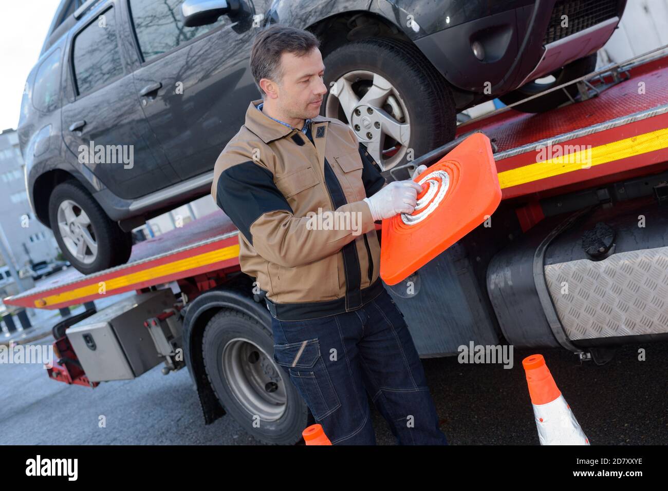 tow truck woker with a towed car Stock Photo