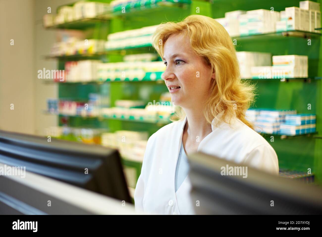 Pharmacist stands behind counter hi-res stock photography and images ...