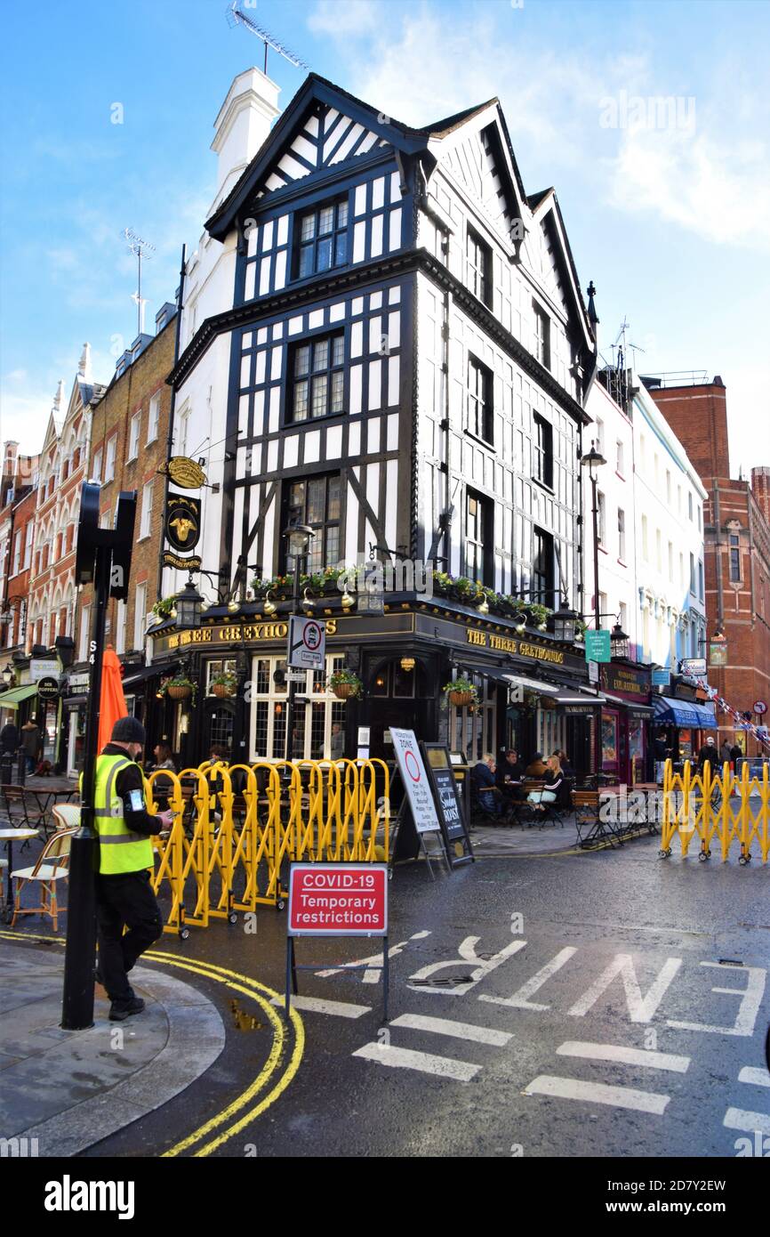 Covid-19 Temporary Restrictions street sign and traffic barriers in Old Compton Street, Soho. Many streets in Central London have been blocked for traffic to allow outdoor street seating during the pandemic. Stock Photo