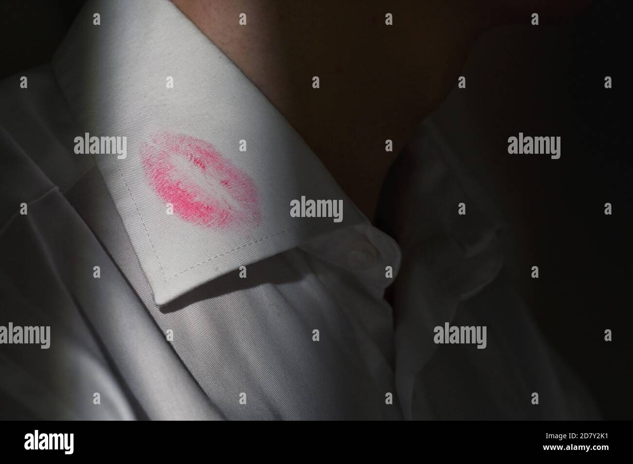 Lipstick marks on the collar of a men's white dress shirt Stock Photo