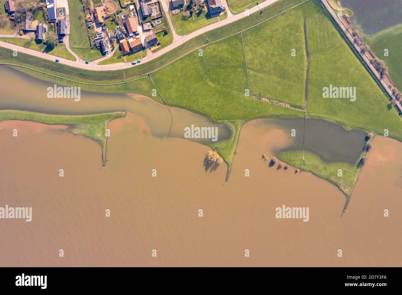 Flooded river landscape with submerged floodplains along river Lek in March near  the village of Ravenswaaij, Gelderland, Netherlands Stock Photo