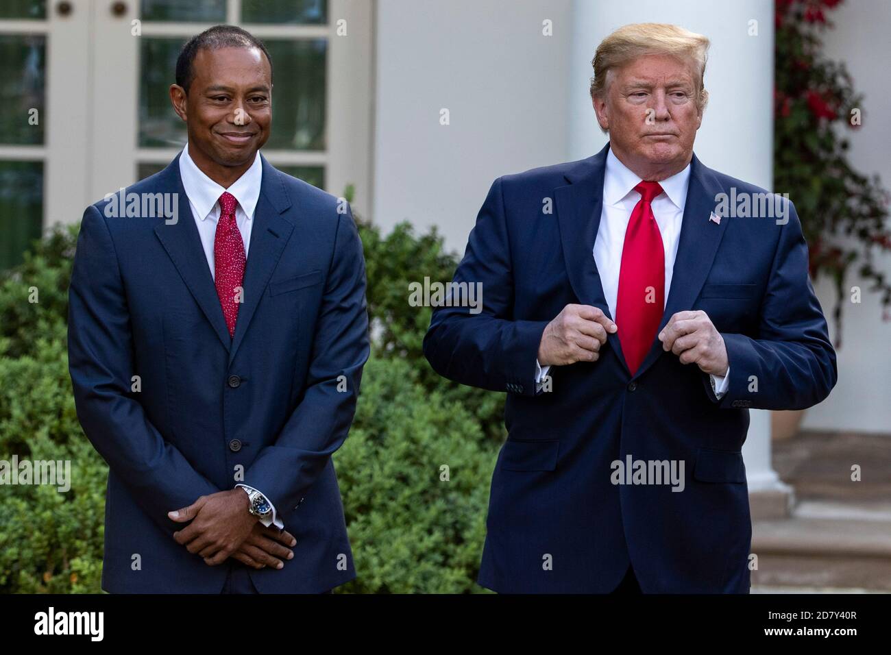 U.S. President Donald Trump adjusts his suit coat as he prepares to award golfer Tiger Woods with the Presidential Medal of Freedom to Woods in the Rose Garden of the White House in Washington, D.C. on Monday, May 6, 2019. The Presidential Medal of Freedom is the highest honor a U.S. President can bestow on a civilian. Woods is the fourth golfer to receive the award. Photographer: Credit: Alex Edelman/The Photo Access Stock Photo