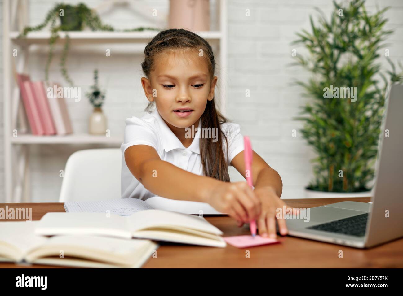 cute little child girl using laptop for online learning system. online ...