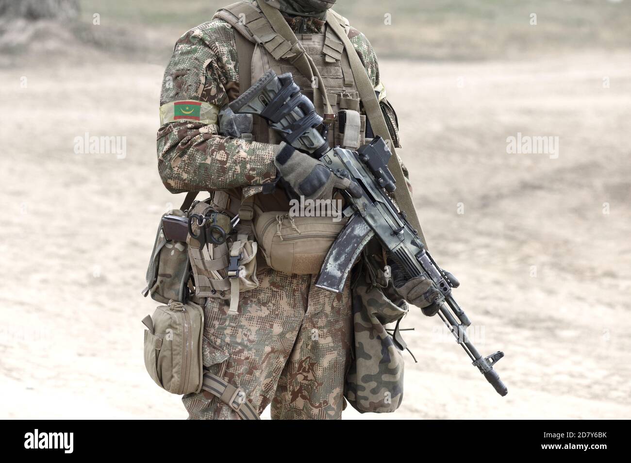 Soldier with assault rifle and flag of Mauritania on military uniform.  Collage Stock Photo - Alamy