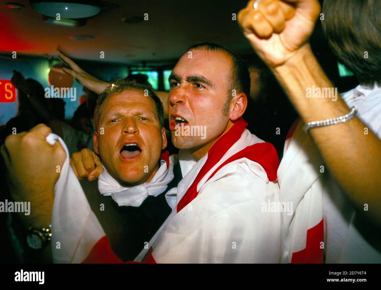 English football fans World Cup 1998. Supporters showing emotions watching a penalty shoot out between England and Argentina that decided the game, Argentina won 4–3 after two English kicks were saved. England was  knocked out of the World Cup. Watching on a multi screens in a television room of the Sports Bar, London 1990s UK HOMER SYKES Stock Photo