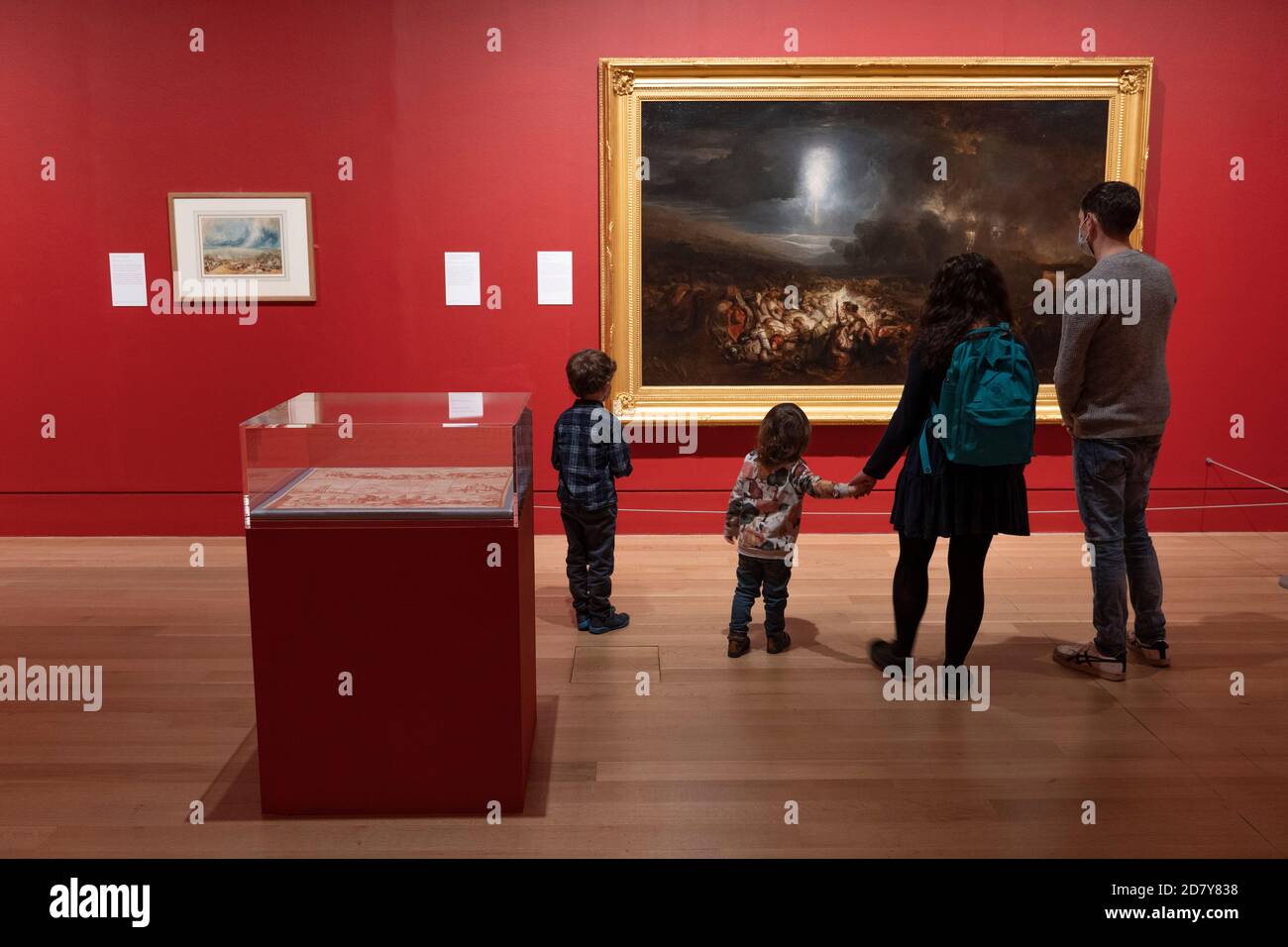 London, England. 26th October 2020. A family looking at Turner’s artwork during the press viewing of Turner’s Modern World at the Tate Britain. Opening on the 28th October 2020, its a major exhibition is dedicated to JMW Turner (1775-1851). Turner’s Modern World reveals how the British landscape painter found new ways to capture daily events, from technology’s impact on the natural world to the effects of modernisation on society. (photo by Sam Mellish / Alamy Live News) Stock Photo