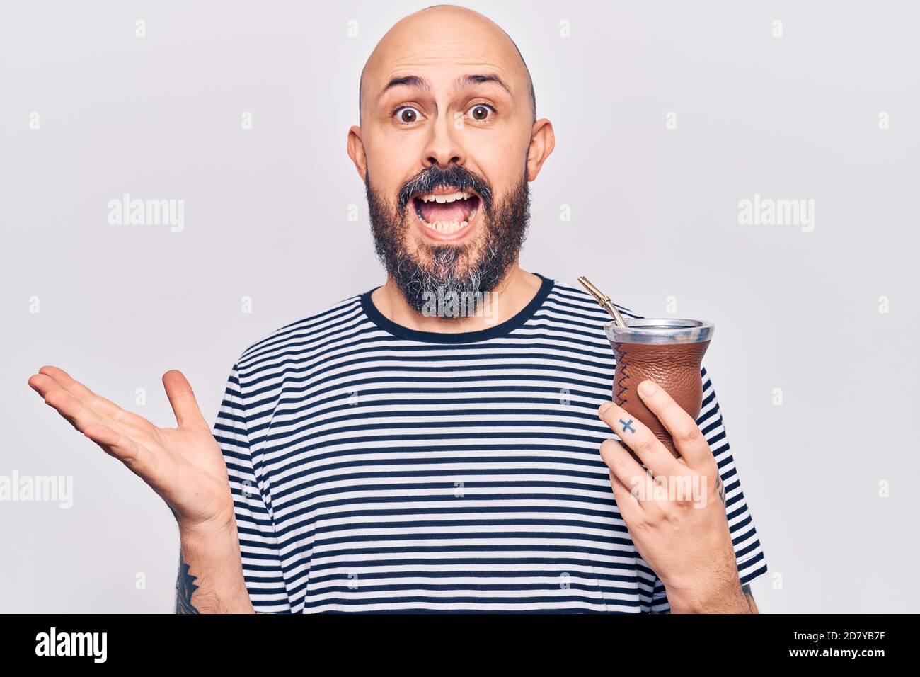 Young handsome man drinking mate infusion celebrating achievement with ...