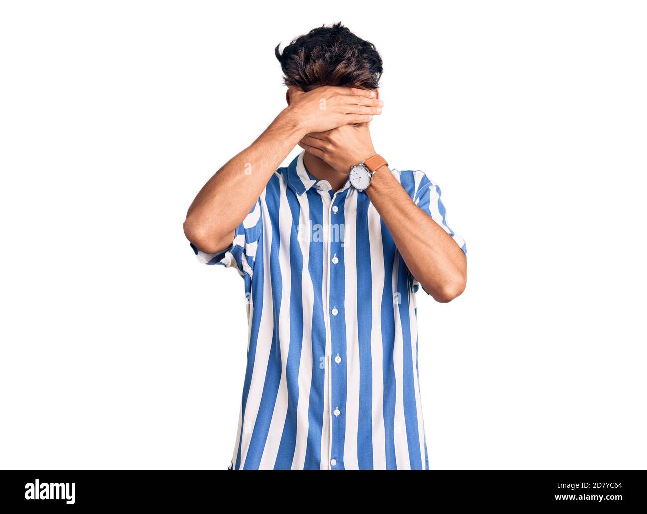 Young hispanic man wearing casual clothes covering eyes and mouth with ...