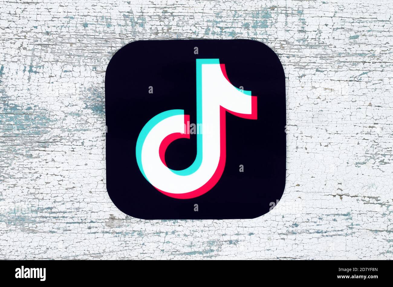 Kiev, Ukraine - August 25, 2020: TikTok icon printed on paper and put on modern wooden background. TikTok is a video-sharing social networking service Stock Photo