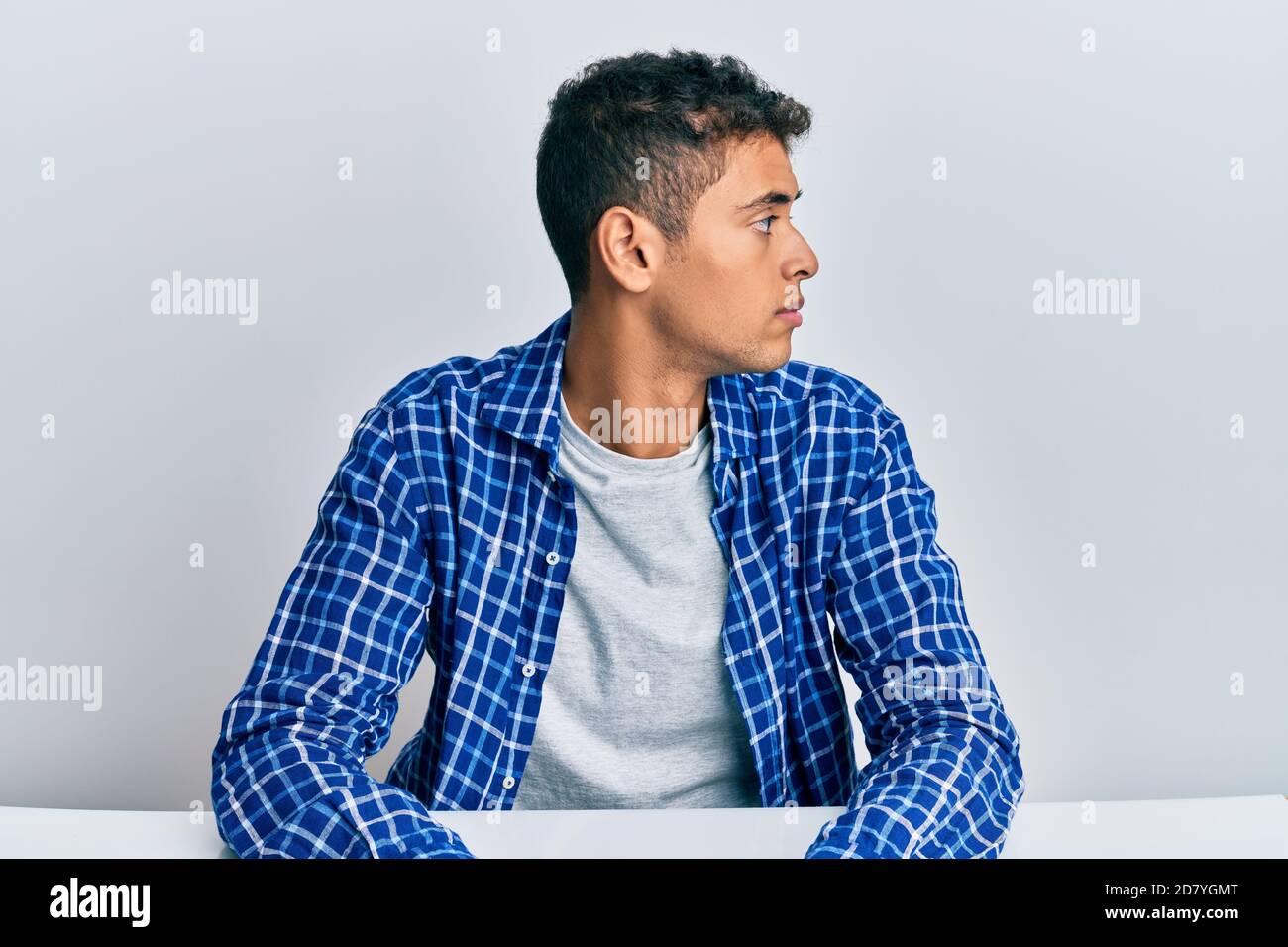 Young handsome african american man wearing casual clothes sitting on ...