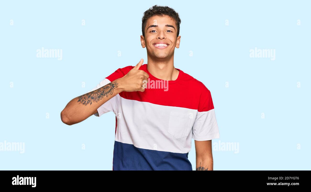 Young handsome african american man wearing casual clothes doing happy ...