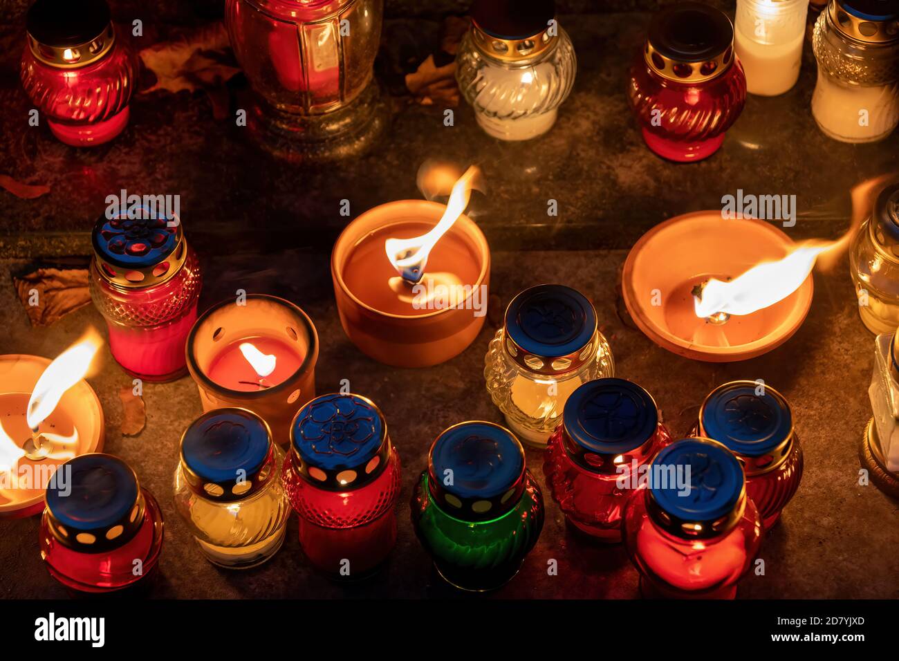 Candle grave lights at night in cemetery on the All Saints Day, Christian tradition. Stock Photo