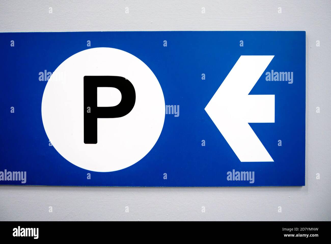 Blue parking sign with white arrow and black capital P on white background. Stock Photo