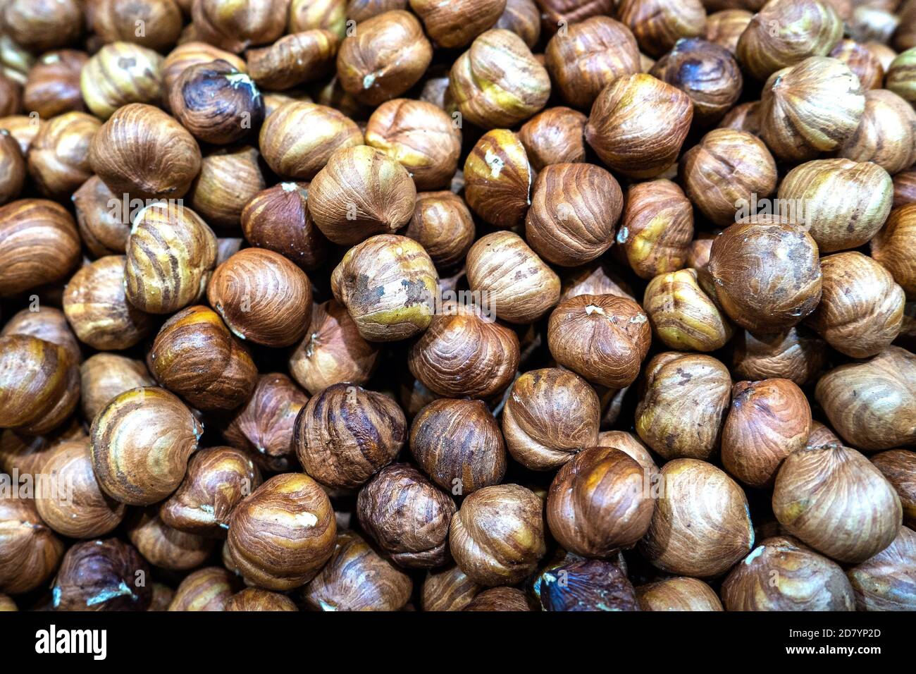 Peeled hazelnuts closeup as abstract food background. Healthy vegan