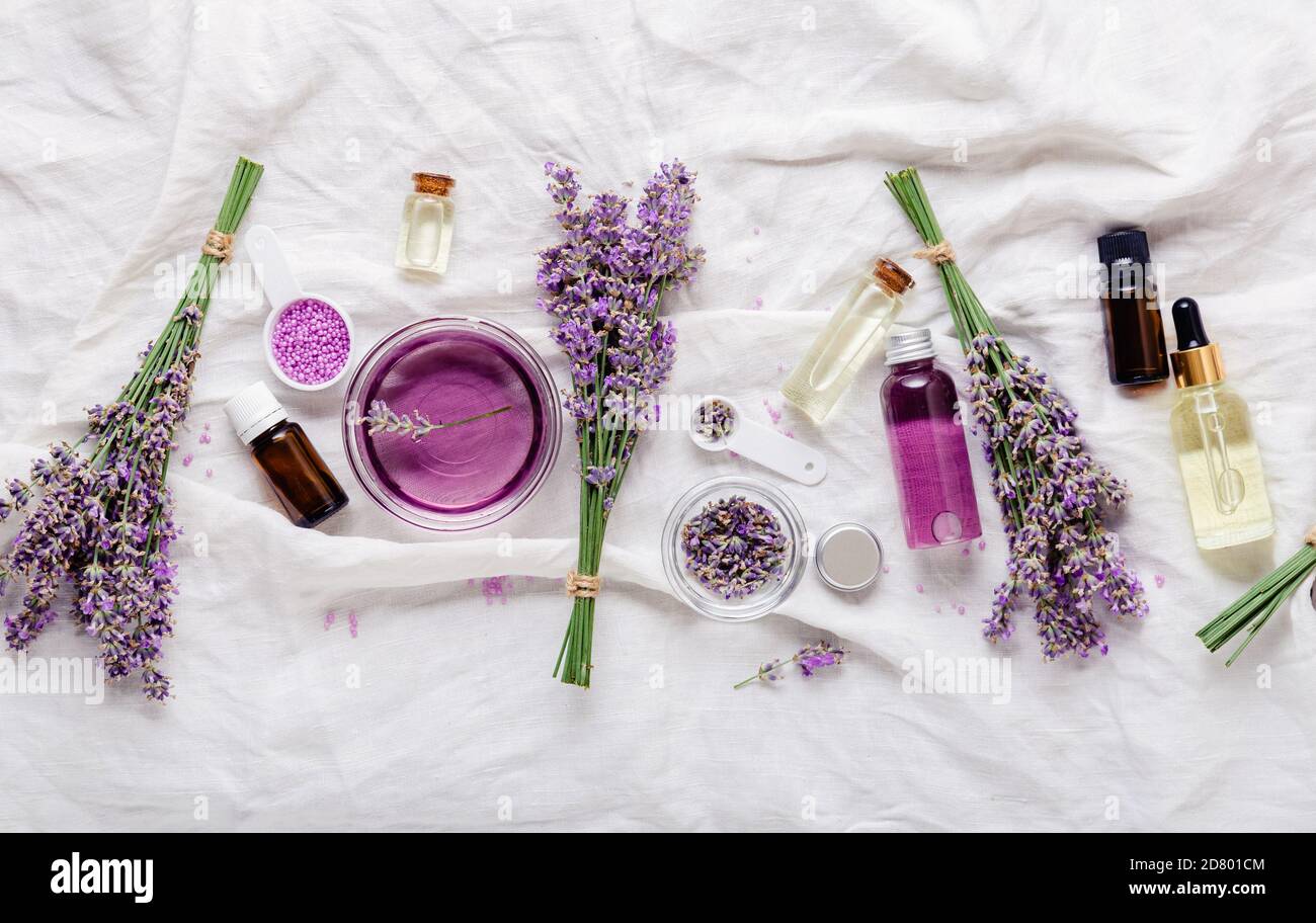 Set lavender oils serum and lavender flowers.Skincare cosmetics products. Natural spa beauty products. Lavender essential oil, serum, body butter Stock Photo