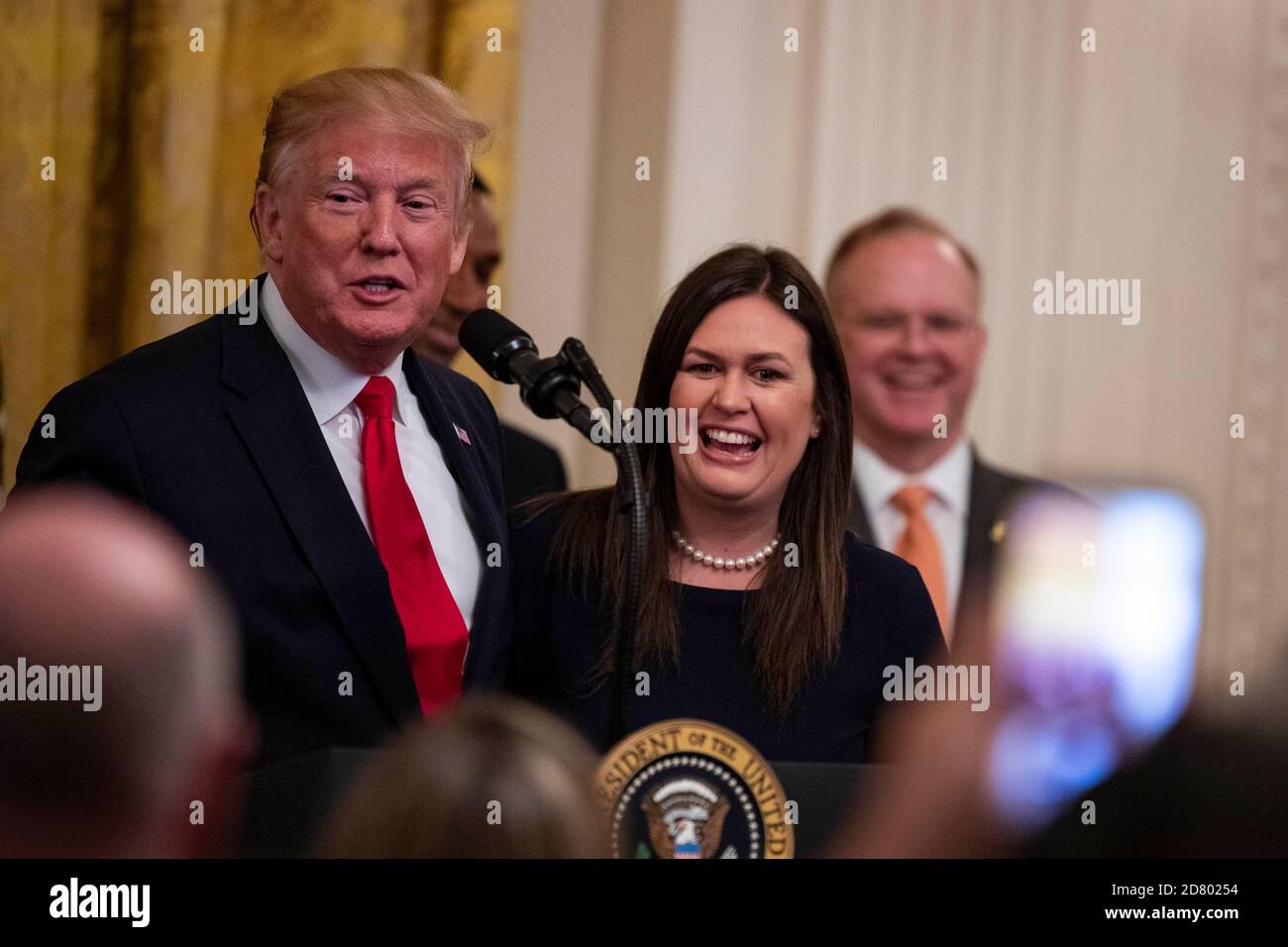 U.S. President Donald Trump speaks as he embraces outgoing White House Press Secretary Sarah Huckabee Sanders as delivers remarks about prison reform in the East Room of the White House in Washington, D.C. on June 13, 2019. Sanders announced today that she will be leaving the White House at the end of the month. Credit: Alex Edelman/The Photo Access Stock Photo