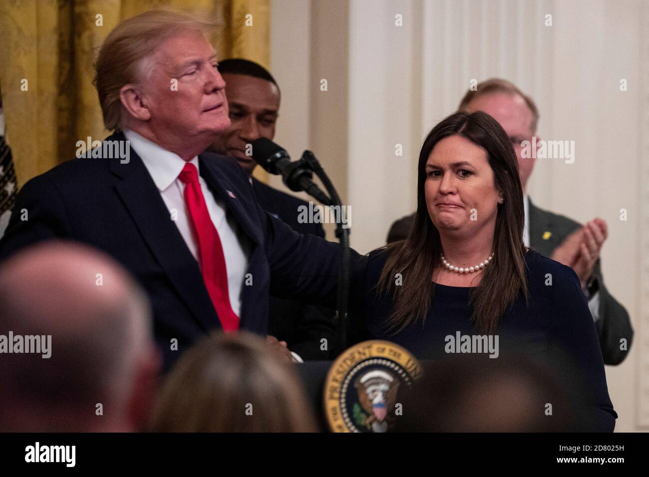 U.S. President Donald Trump speaks as he embraces outgoing White House Press Secretary Sarah Huckabee Sanders as delivers remarks about prison reform in the East Room of the White House in Washington, D.C. on June 13, 2019. Sanders announced today that she will be leaving the White House at the end of the month. Credit: Alex Edelman/The Photo Access Stock Photo