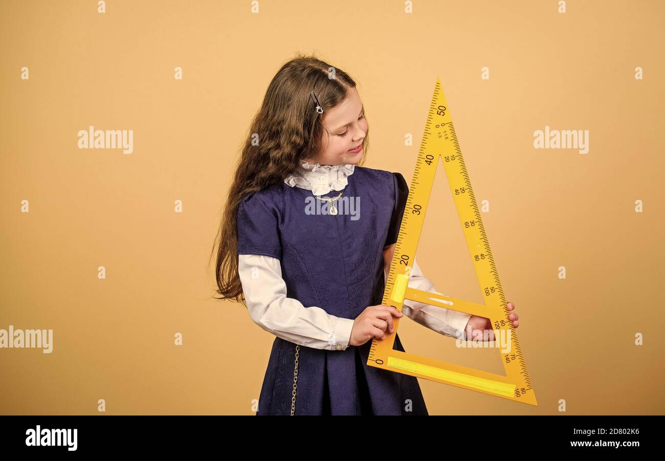 Pupil Using Ruler School student learning geometry. Pupil girl with big ruler. math ...