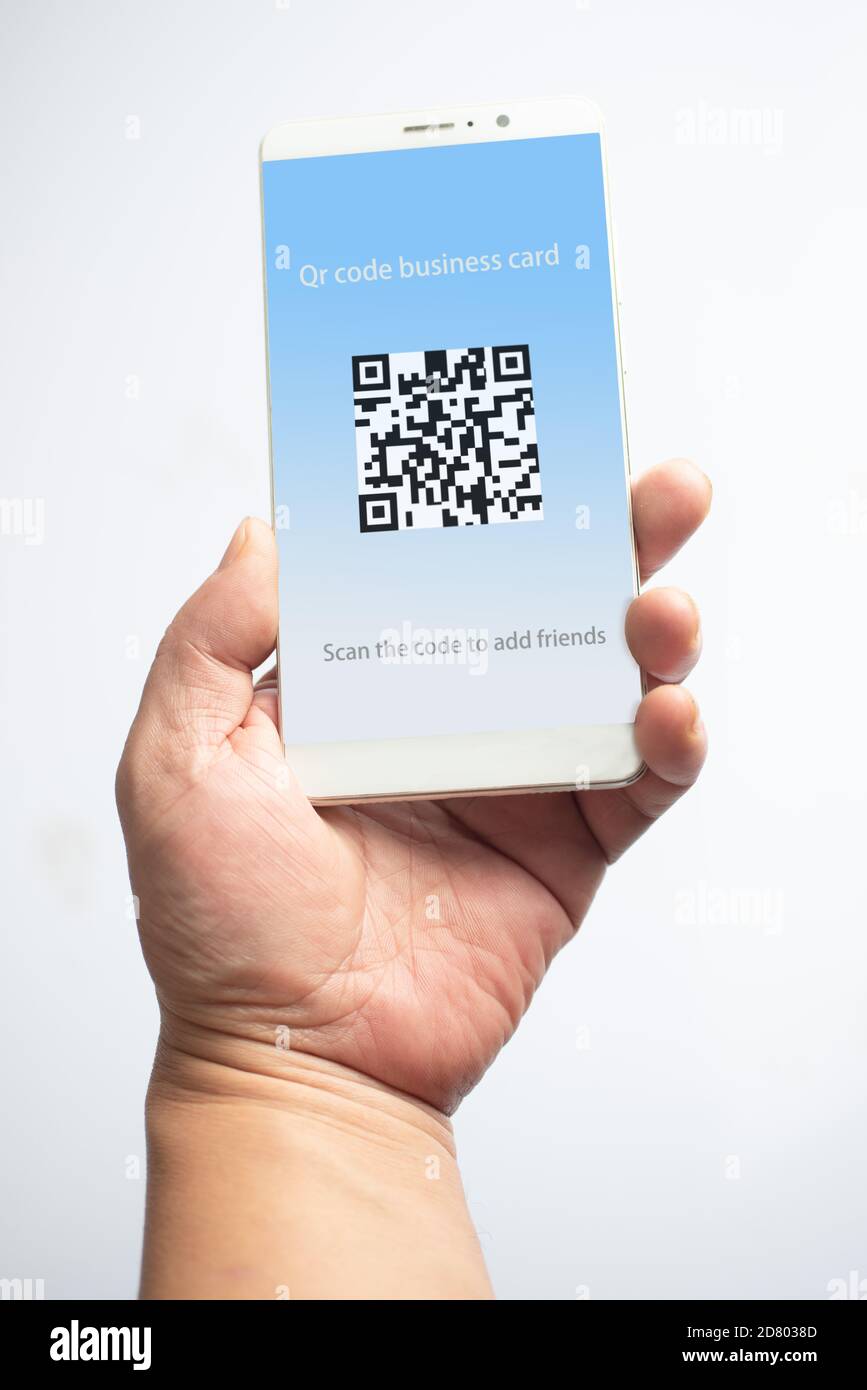 Holding the mobile phone, the qr code card is displayed on the screen Stock Photo