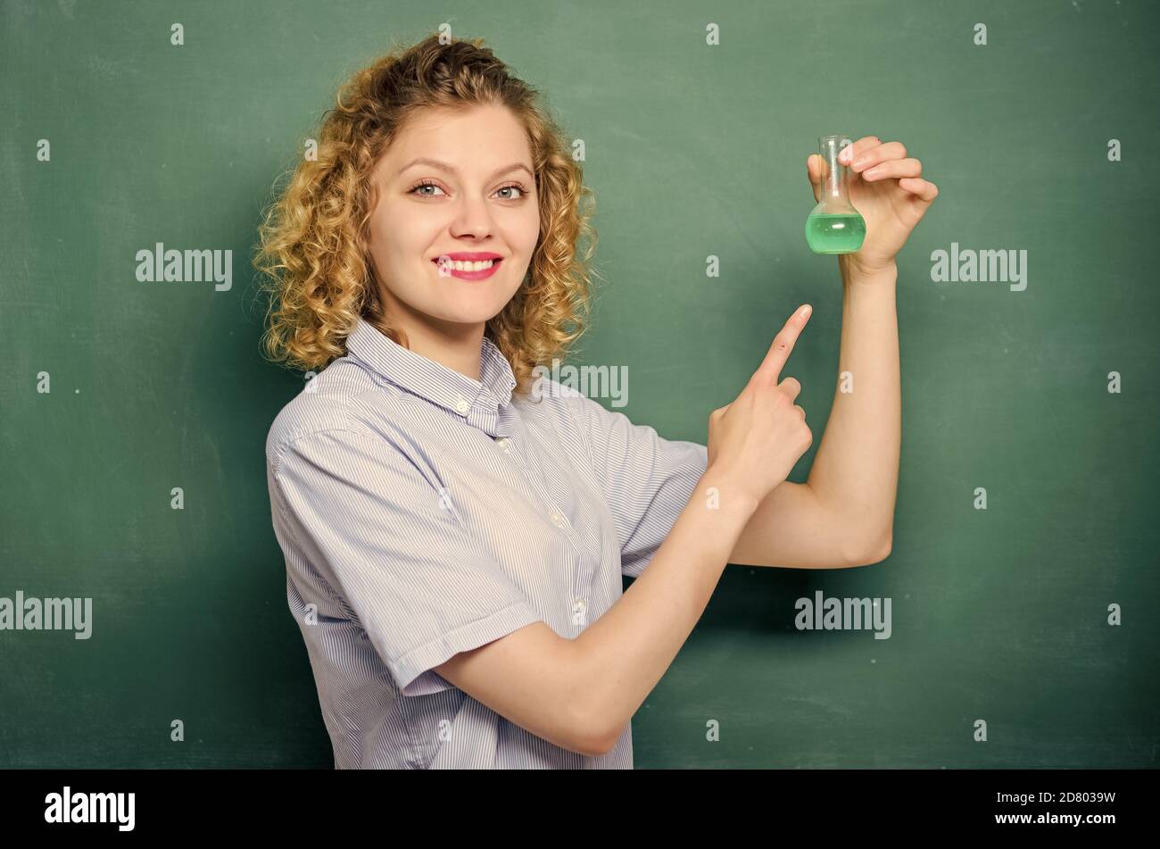 girl hold chemical flask with liquid. biology experiment. sample