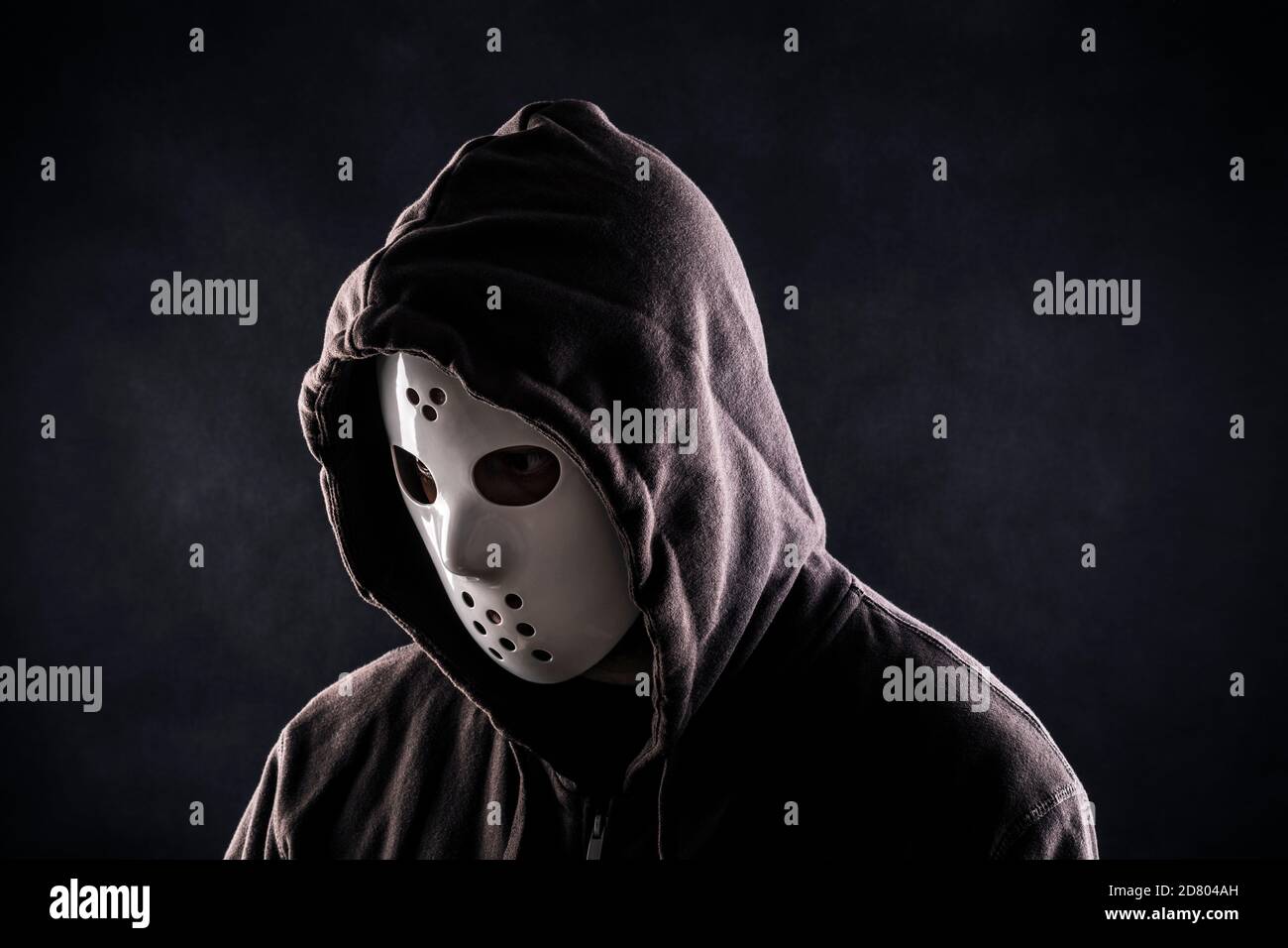 Hooded maniac or criminal in mask Stock Photo