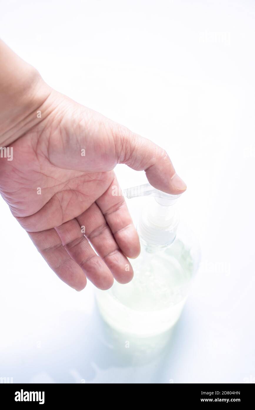 Press the hand sanitizer nozzle with your hand Stock Photo