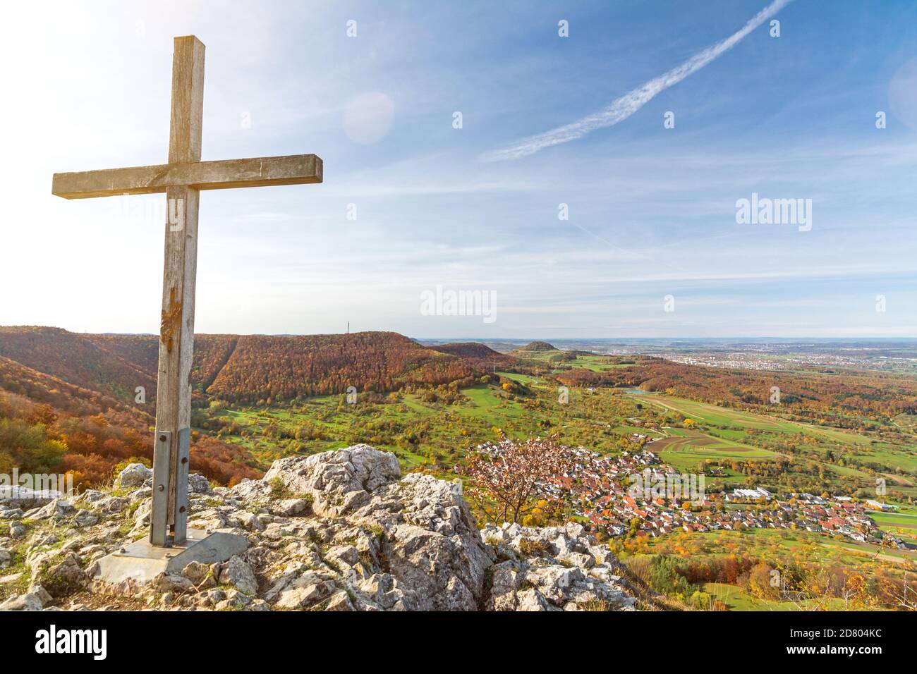Summit cross on a rocky mountain peak overlooking beautiful autumn landscape in the Swabian Jura Stock Photo