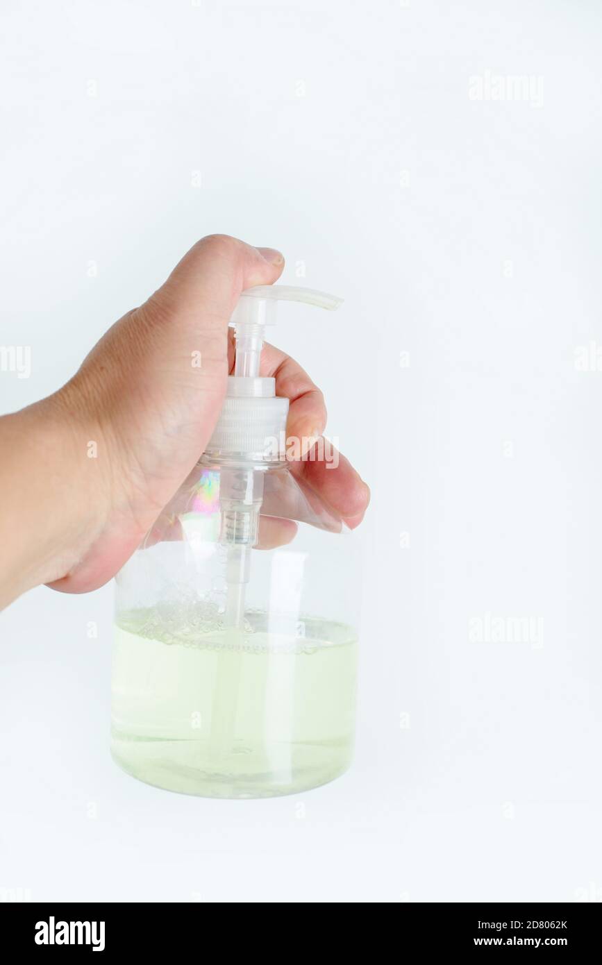 Press the hand sanitizer nozzle with your hand Stock Photo
