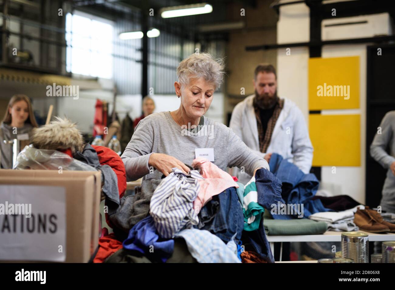 Volunteers sorting out donated clothes in community charity donation