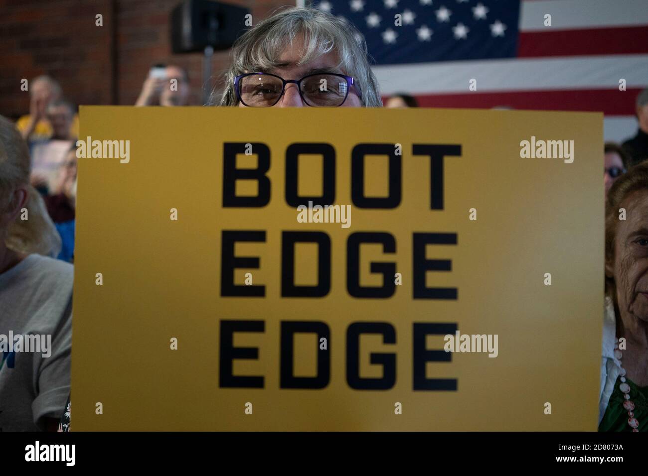 A supporter holds a campaign sign as 2020 Democratic Presidential hopeful, South Bend, Indiana Mayor, Pete Buttigieg speaks during a campaign event in Burlington, Iowa on August 14, 2019. Credit: Alex Edelman/The Photo Access Stock Photo