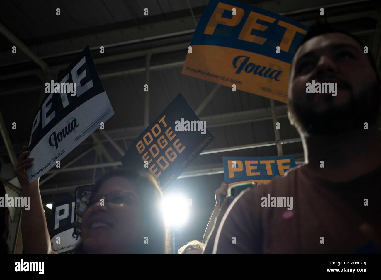 Supporters hold campaign signs as 2020 Democratic Presidential hopeful, South Bend, Indiana Mayor, Pete Buttigieg speaks during a campaign event in Burlington, Iowa on August 14, 2019. Credit: Alex Edelman/The Photo Access Stock Photo