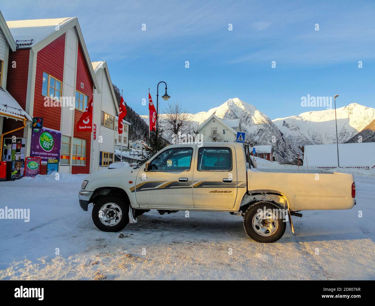Pick up truck cars, buildings and tourism in winter in Balestrand